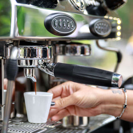 Barista making coffee using professional espresso machineの写真素材