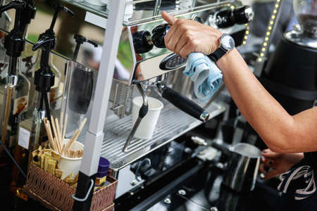 Barista making coffee using professional espresso machineの写真素材
