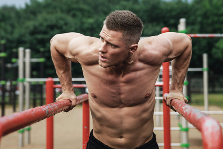 Muscular man during his workout on the street