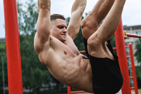 Muscular man during his workout on the street