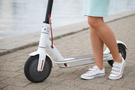 Female legs on the electric scooterの写真素材