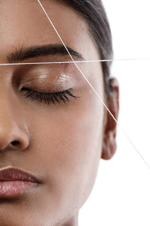 Eyebrow threading - epilation procedure for brow shape correctionの写真素材