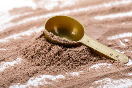 Closeup of scoop with a chocolate protein powderの写真素材