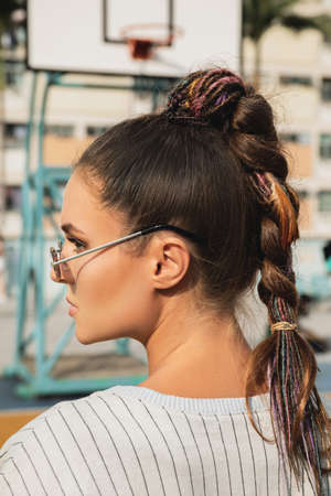 Young woman with a trendy hairstyle wearing sunglassesの写真素材