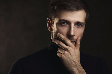 Young handsome man wearing a polo neck