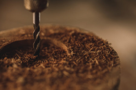 Close-up of drill bit in the piece of wood