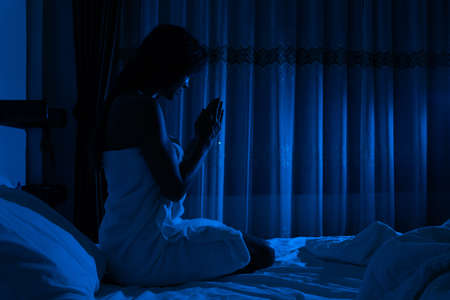 Young girl praying before going to sleepの写真素材