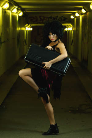 Strange and freaky woman in the dark tunnelの写真素材