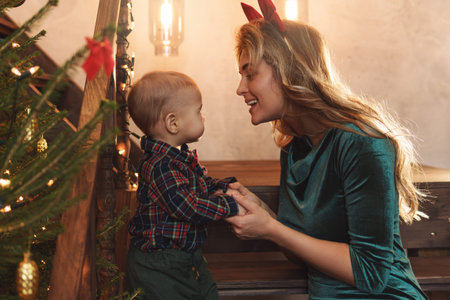 Happy mother and her cute little son are celebrating Christmas or New year.