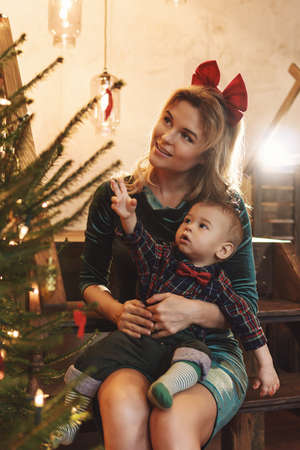 Happy mother and her cute little son are celebrating Christmas or New year.の写真素材
