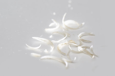 Pile of nail clipping on white background