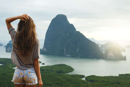 Young woman looking at the beautiful landscapeの写真素材