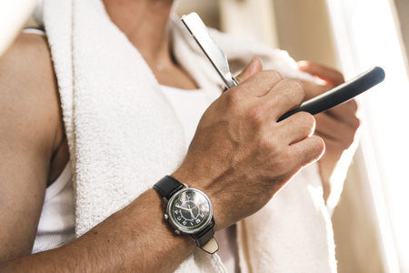 Man shaving his beard with a straight razor