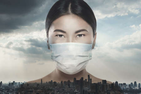 Asian woman is wearing facial mask during virus epidemicの写真素材