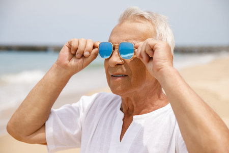 Happy senior man walking on the beach