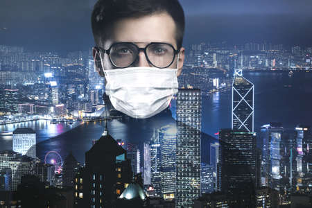 Man wearing facial mask against the city backgroundの写真素材