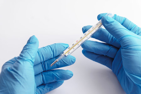 Doctor is checking result of the body temperature measurement