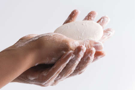 Close-up of female hands with a soapの写真素材