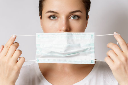 Young woman is wearing a face mask for protection against virus
