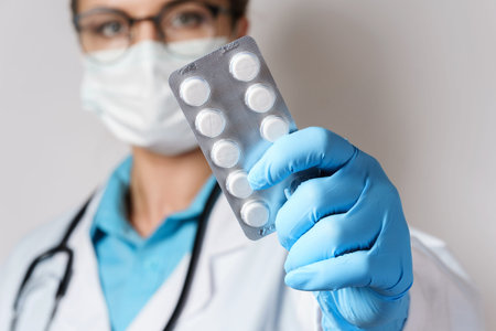 Female doctor and pills in foil packaging