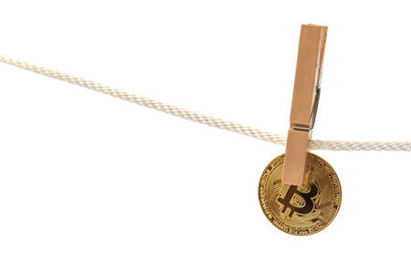 Bitcoin is hung on a rope with clothespins.の写真素材