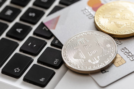 Credit card and bitcoin on the computer keyboard