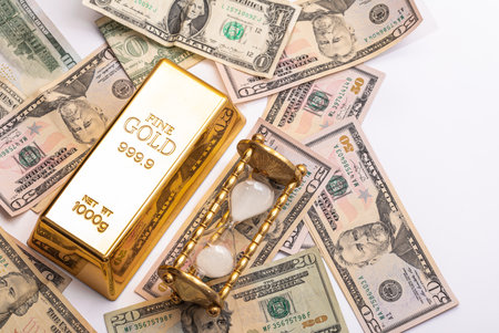 Gold bar, US dollar bills and hourglassの写真素材