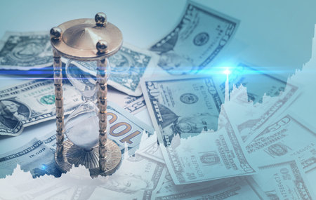 Rising diagram, hourglass and US dollar bills.