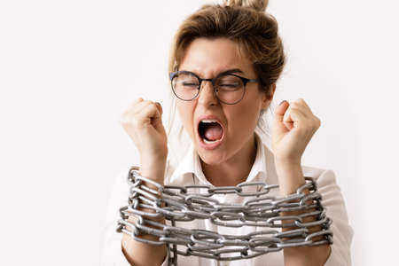 Businesswoman tied up with a chains is screamingの写真素材