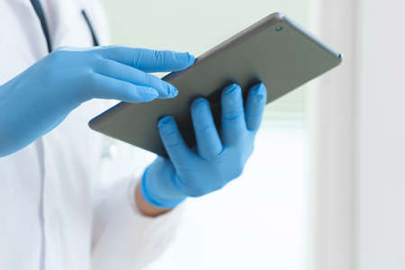 Closeup of doctors hands with a tablet pcの写真素材