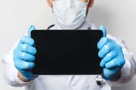 Doctor holding tablet pc with empty spaceの写真素材
