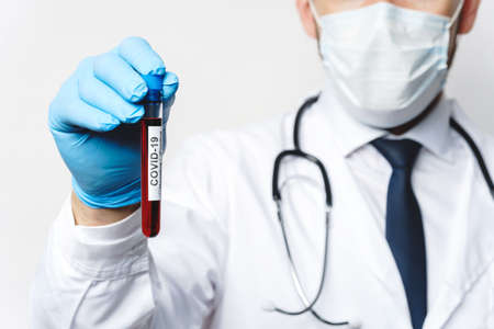 Doctor is holding a blood sample of the COVID-19の写真素材