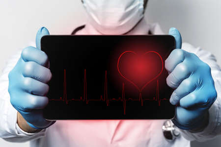 Tablet PC with a heartbeat rhythm on the displayの写真素材
