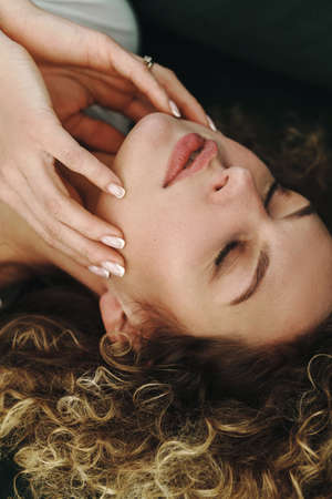 Young beautiful woman with a curly hair and smooth hairの写真素材