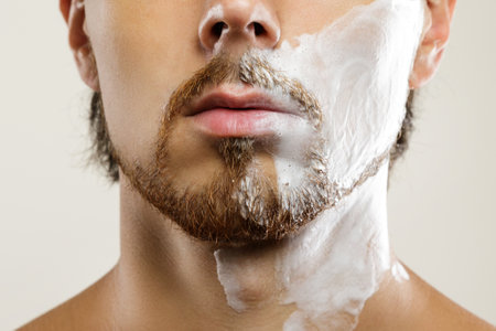 Man with a shaving cream on his faceの写真素材