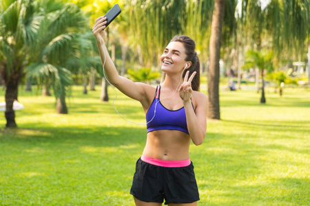 Woman taking selfie during her workout in the city park