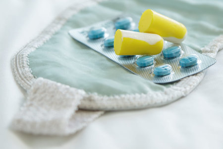 Concept of insomnia. Earplugs, blindfold and sleeping pillsの写真素材