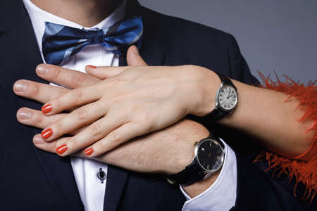 Closeup of well dressed stylish couple wearing wristwatchesの写真素材