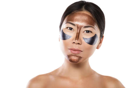 Young asian woman with a purifying peel-off mask on her faceの写真素材