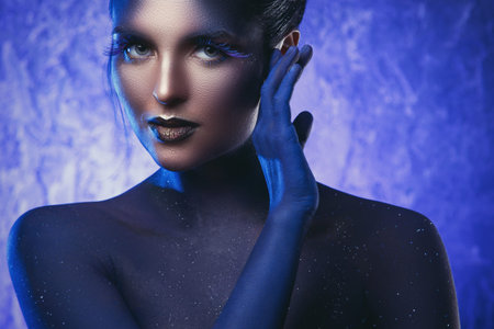 Beautiful woman with a creative makeup and body-artの写真素材