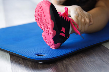 Woman doing stretching exercise in the gym