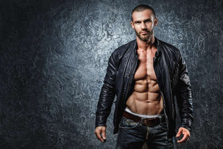 Handsome young bodybuilder showing his muscular bodyの写真素材