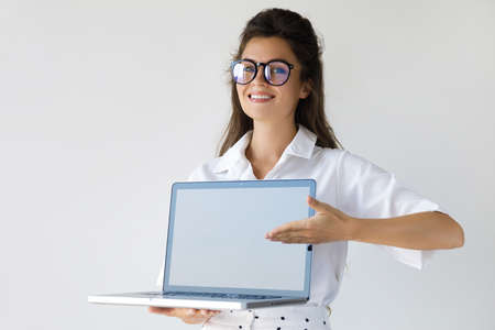 Young businesswoman with a laptop computer in her handsの写真素材