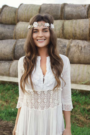 Woman wearing stylish white dress in the country sideの写真素材