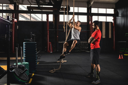 Sportsman and his trainer during workout in the gym