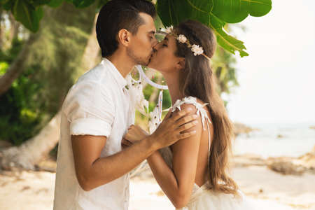 Just married couple is celebrating their wedding on the beachの写真素材