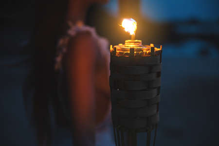 Close-up of bamboo torch light on the beachの写真素材
