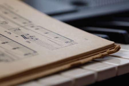Close up of sheet music on the piano keysの写真素材