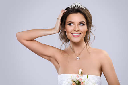 Portrait of young beautiful bride with bouquet of flowersの写真素材