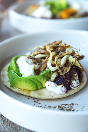 Tortilla with avocado, fresh cheese, beetroot and oyster mushroomsの写真素材